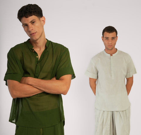 Two men in breathable yoga tops — one in sheer Mehndi green cotton, the other in soft natural linen, standing in quiet strength.