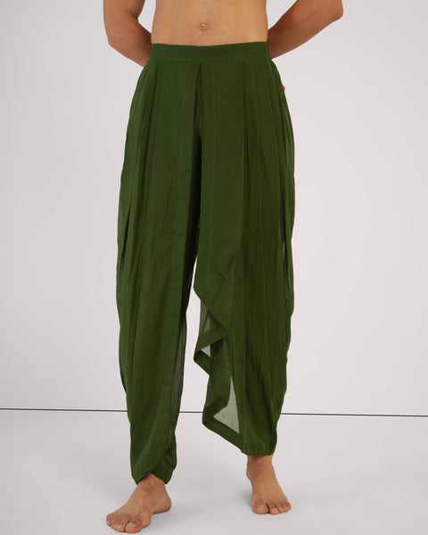 Male standing relaxed, front view, wearing Mehndi green cotton yoga pants, breathable natural fabric, white studio background.