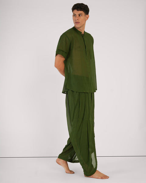 Male standing side profile in Mehndi green 100% cotton yoga set, breathable natural fabric, white studio background.