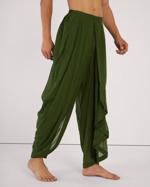 Male in side view standing casually, wearing Mehndi green cotton yoga pants, natural breathable fabric, white studio background.