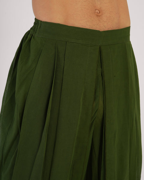 Close-up side view of male wearing Mehndi green 100% cotton yoga pants, elastic waistband visible, natural breathable fabric on white studio background.