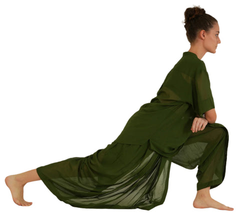 Woman in deep green Mehndi YogaFlow set holding a low lunge — sheer cotton draping fluidly as she grounds into the asana.