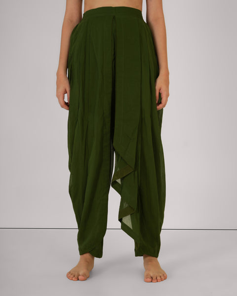 Front view of female wearing Mehndi green 100% cotton yoga pants, natural breathable fabric, standing straight, white studio background.