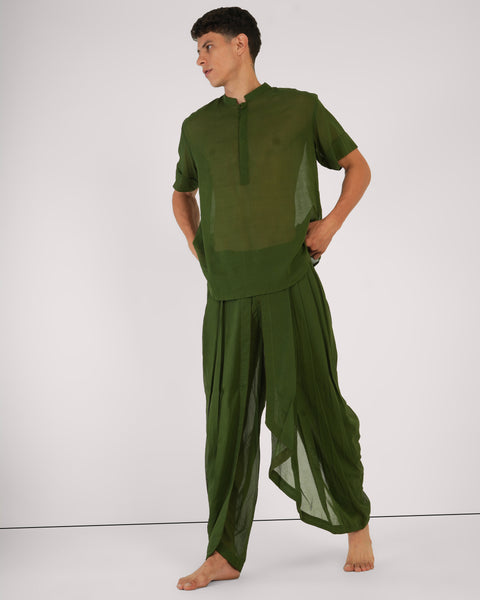 Male standing with relaxed posture, front view, in Mehndi green cotton yoga set, natural breathable fabric, white studio background.
