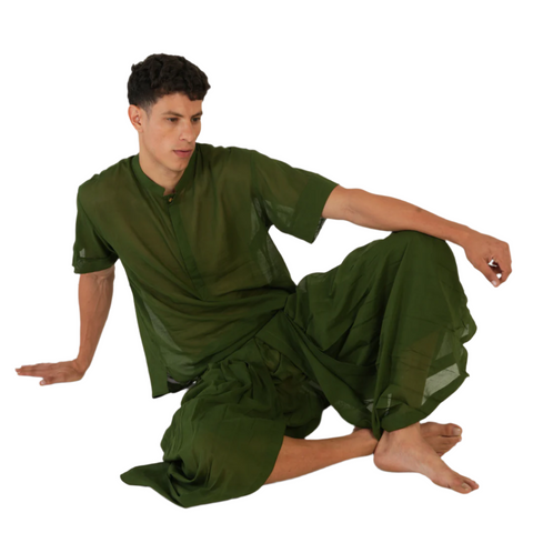 Man seated in deep green Mehndi YogaFlow set — 100% cotton yoga clothing designed for breath, stillness, and earthy flow.