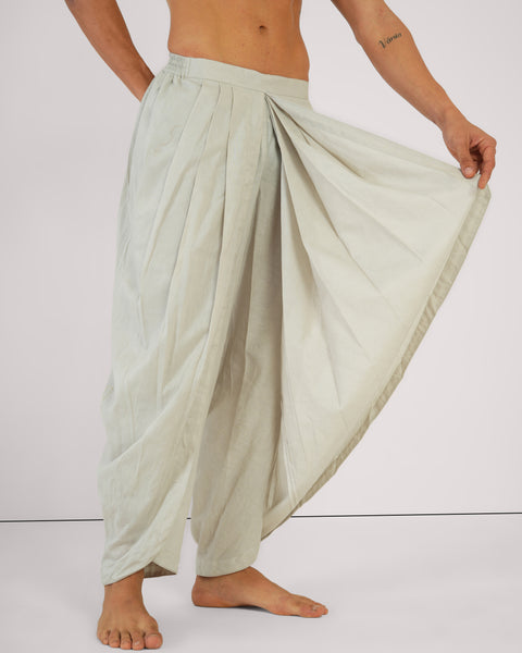 Male side-view showcasing drape of Vibhuti Grey linen cotton yoga pants, breathable natural fabric, studio white background.