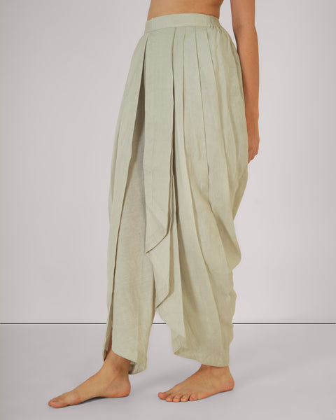 Female standing relaxed, side profile, in Vibhuti Grey linen cotton yoga pants, natural breathable fabric, white studio background.