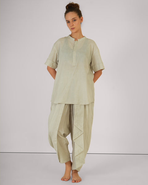 Female standing casually, front view, wearing Vibhuti Grey linen cotton yoga set, breathable natural fabric, white studio background.